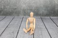 Wooden illustration model figure on a wooden plank surface