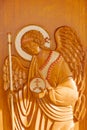 Wooden image of an angel on a background of a tree in the holy church