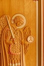 Wooden image of an angel on a background of a tree in the holy church