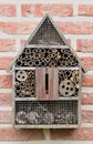 Wooden insect hotel on a brick wall Royalty Free Stock Photo