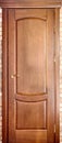 Wooden interior door made of maple wood with brass handle with g