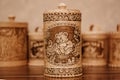 A wooden jar of tuesok, with an image of a bear on i