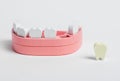 Wooden jaw model and fallen out bad tooth with plaque, cavity. Teeth diseases, inflammation, poor oral hygiene concept