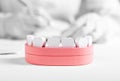Wooden jaw model with teeth and dentist hands in background. Dental health, oral hygiene, check for tooth disease Royalty Free Stock Photo