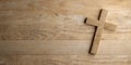 Wooden Jesus Christ christian crucifix or cross on wood table background with copy space, god, resurrection or christianity