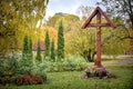 Wooden Jesus Christ crucifix perched in a colorful autumn park Royalty Free Stock Photo