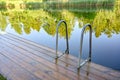 wooden jetty with bathing ladder in early morning