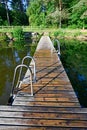 wooden jetty with bathing ladder in early morning