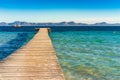 Spain Majorca island, wooden pier with sea and mountain landscape at the bay of Alcudia coast Royalty Free Stock Photo