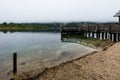 Wooden jetty in the beautiful Lake Bohinj in the Triglav National Park in Slovenia on misty morning in autumn Royalty Free Stock Photo