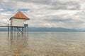 Wooden jetty and boathouse on Lake Weissensee, Carinthia, Austria under cloudy sky