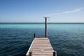 wooden jetty for boats on a blue and blue crystalline Caribbean sea. Caribbean vacation with a dedicated boat dock Royalty Free Stock Photo