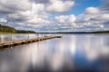 Wooden jetty over lake in south Sweden. Royalty Free Stock Photo