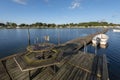 Wooden Jetty in Stangeskroken bay in Sweden. The coastal camping side of Landon village is at background. Jamtland Royalty Free Stock Photo