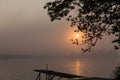 Wooden jetty sunrise over the river maas in Holland