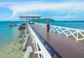 wooden jetty walkway with pavillion to the sea