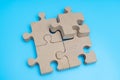 Wooden Jigsaw Puzzle parts on blue background. four puzzles form a rectangle on blue background. Royalty Free Stock Photo