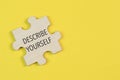 Wooden jigsaw puzzle with phrase DESCRIBE YOURSELF