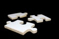 Wooden jigsaw puzzle pieces on black background