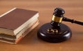 Wooden judge gavel, books and golden rings, divorce concept