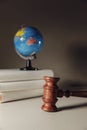 Wooden Judge gavel and globe. International environment law concept. Vertical image Royalty Free Stock Photo