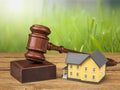 Wooden judge gavel and house on table Royalty Free Stock Photo