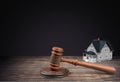 Wooden judge gavel and house on table Royalty Free Stock Photo