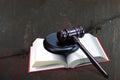 Wooden judge gavel and red book on barbed wire background as symbol of of rule of law with judge`s gavel, justice with judge`s ga