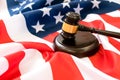 Wooden judge gavel and soundboard laying over US flag. Hammer and gavel. American law and justice concept. bidding Royalty Free Stock Photo