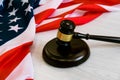 Wooden judge gavel and soundboard laying over US flag. Hammer and gavel. American law and justice concept. bidding Royalty Free Stock Photo