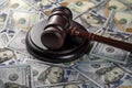 Wooden judge gavel, soundboard with US 100 dollar bills on the background, closeup. Finance and justice concept Royalty Free Stock Photo