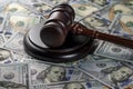 Wooden judge gavel, soundboard with US 100 dollar bills on the background, closeup. Finance and justice concept Royalty Free Stock Photo