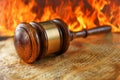 Wooden Judge Gavel on a Sounding Block with Fiery Background Symbolizing Hot Legal Issues