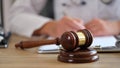 Wooden judge gavel on table doctor doing paperwork on blurred background Royalty Free Stock Photo