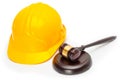 Wooden judge gavel with yellow protective helmet - studio shoot