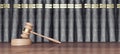 Wooden judge hammer on the desk in front of the law books