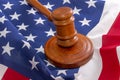 Wooden judge`s gavel on the background of the American flag. Concept: claim and compensation for damages, court session, announcem Royalty Free Stock Photo