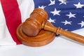 Wooden judge`s gavel on the background of the American flag. Concept: claim and compensation for damages, court session, announcem Royalty Free Stock Photo