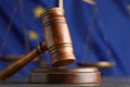 Wooden judge`s gavel and Scales of justice on grey table against European Union flag, closeup Royalty Free Stock Photo