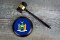 Wooden judgement or auction mallet with of New York flag.