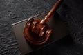 Wooden judges gavel lying on a law book in a courtroom for dispensing justice and sentencing crimes Royalty Free Stock Photo