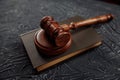 Wooden judges gavel lying on a law book in a courtroom for dispensing justice and sentencing crimes Royalty Free Stock Photo