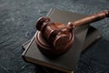 Wooden judges gavel lying on a law books in a courtroom for dispensing justice and sentencing crimes Royalty Free Stock Photo