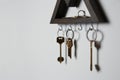 Wooden key holder on grey wall. Space for text Royalty Free Stock Photo