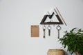 Wooden key holder and to do list on grey wall indoors. Space for text Royalty Free Stock Photo