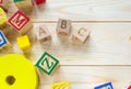 Wooden kids cubes ABC on wooden table. Educational toys blocks, pyramid, pencils, numbers. Toys for kindergarten, preschool Royalty Free Stock Photo