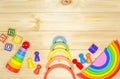 Wooden kids cubes ABC on wooden table. Educational toys blocks, pyramid, pencils, numbers. Toys for kindergarten, preschool or day Royalty Free Stock Photo