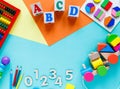 Wooden kids toys on colourful paper. Educational toys blocks, numbers, letters, train. Toys for kindergarten, preschool