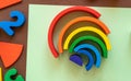 Wooden kids toys on colourful paper. Educational toys, blocks, pyramid, pencils, numbers, rainbow. Toys for kindergarten, Royalty Free Stock Photo