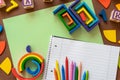 Wooden kids toys on colourful paper. Educational toys, blocks, pyramid, pencils, numbers, rainbow. Toys for kindergarten, Royalty Free Stock Photo
